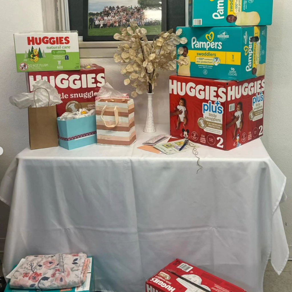 diapers on gift table at baby shower