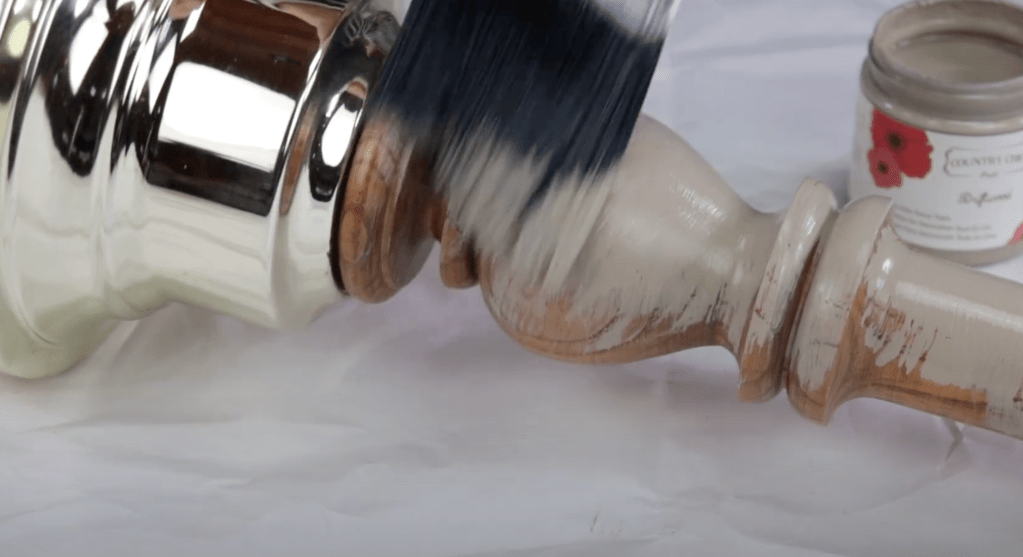 close up of someone painting a table lamp with driftwood paint from country chic paint