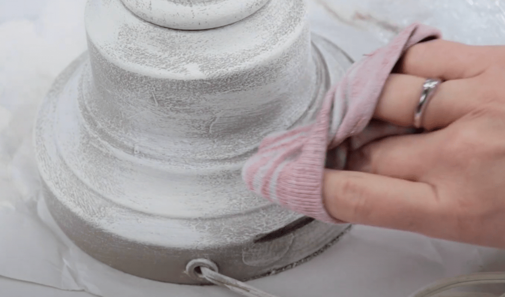 up close photo of someone using a old sock to rub on antiquing wax