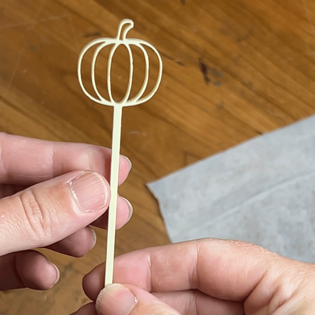close up of an acrylic pumpkin stick drink topper cut with a thunder laser