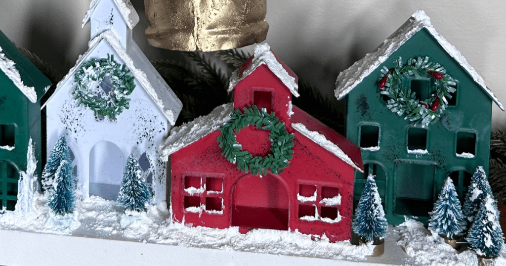 close up of dollar tree house ornaments plastic covered with snow tex and little green bottle brush trees