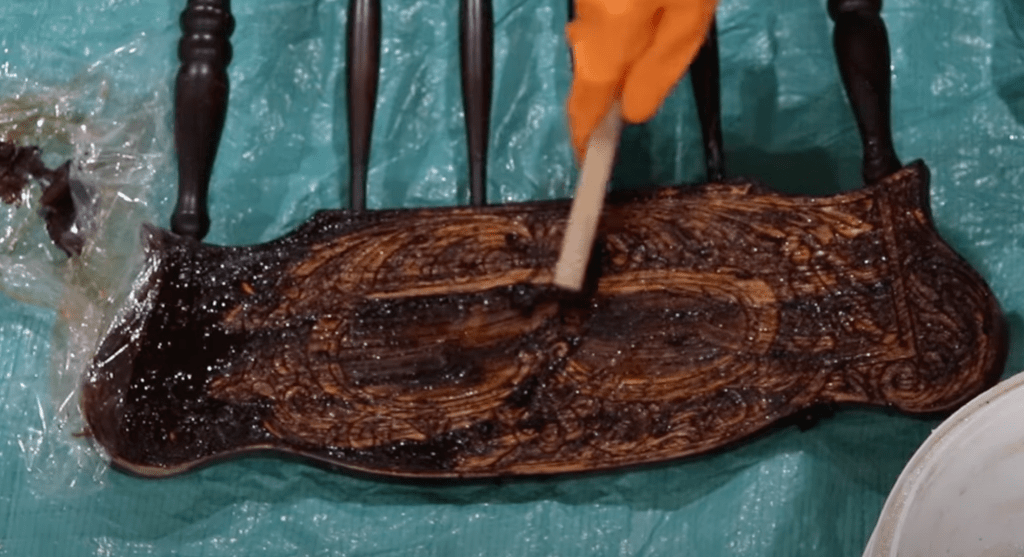 scraping paint stripper off head of antique chair