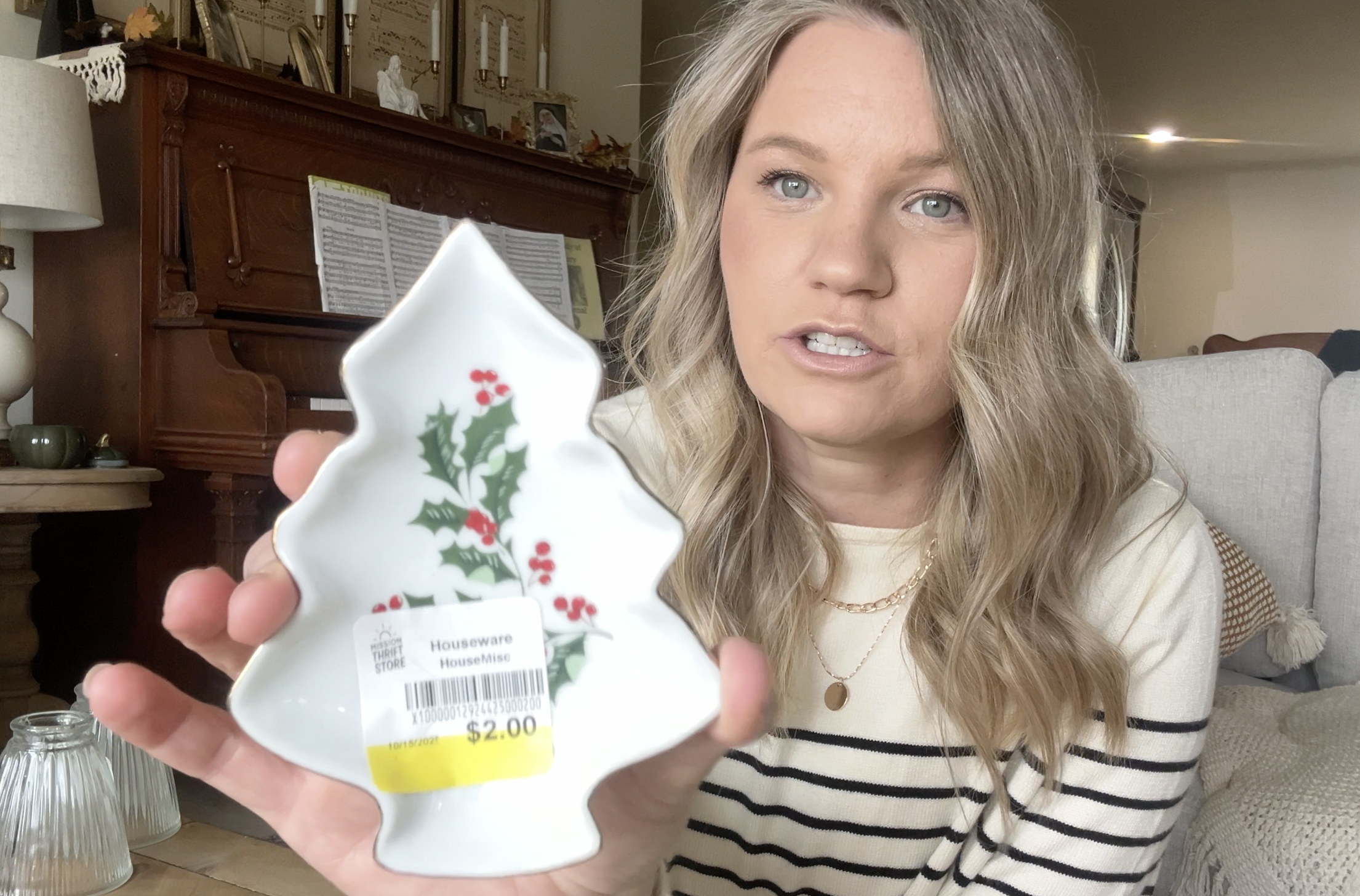 blond woman holding a small christmas tree shaped tray in her hand showing it to the camera